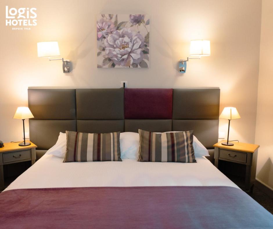 Un ou plusieurs lits dans un hébergement de l'établissement Hôtel Spa & Restaurant Ô Pervenches