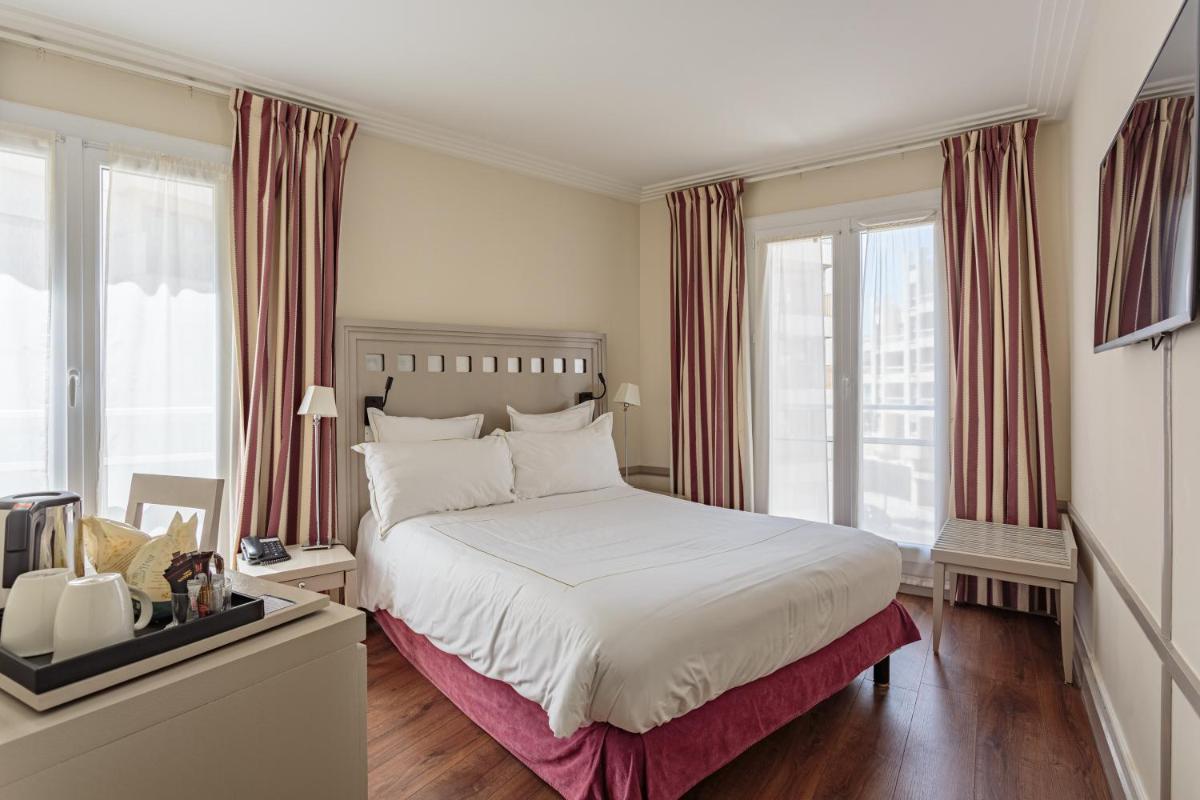Un ou plusieurs lits dans un hébergement de l'établissement Grand Tonic Hotel & SPA NUXE