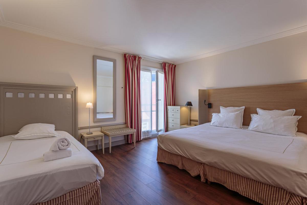 Un ou plusieurs lits dans un hébergement de l'établissement Grand Tonic Hotel & SPA NUXE