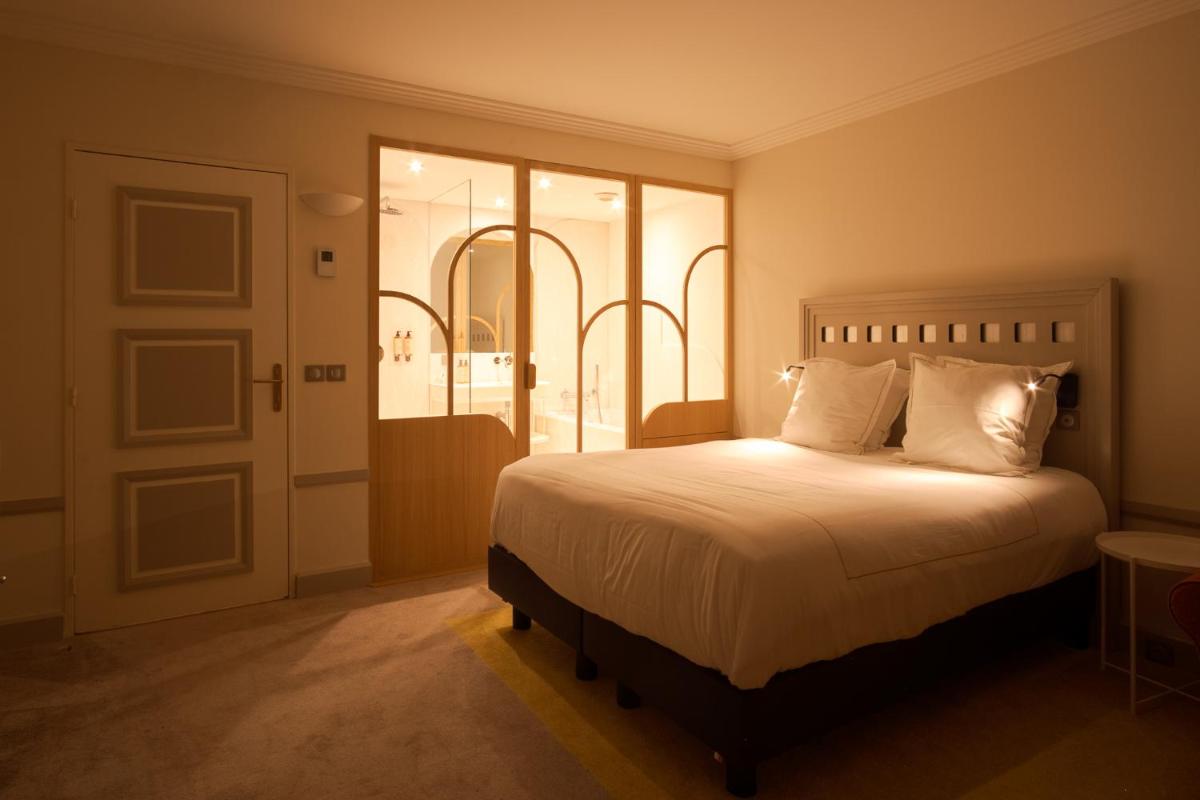 Un ou plusieurs lits dans un hébergement de l'établissement Grand Tonic Hotel & SPA NUXE