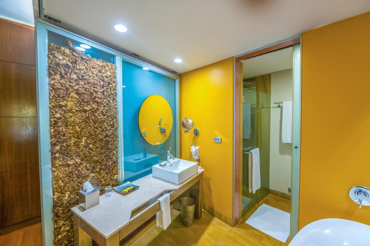 a bathroom with a sink and a mirror at O Hotel Pune in Pune