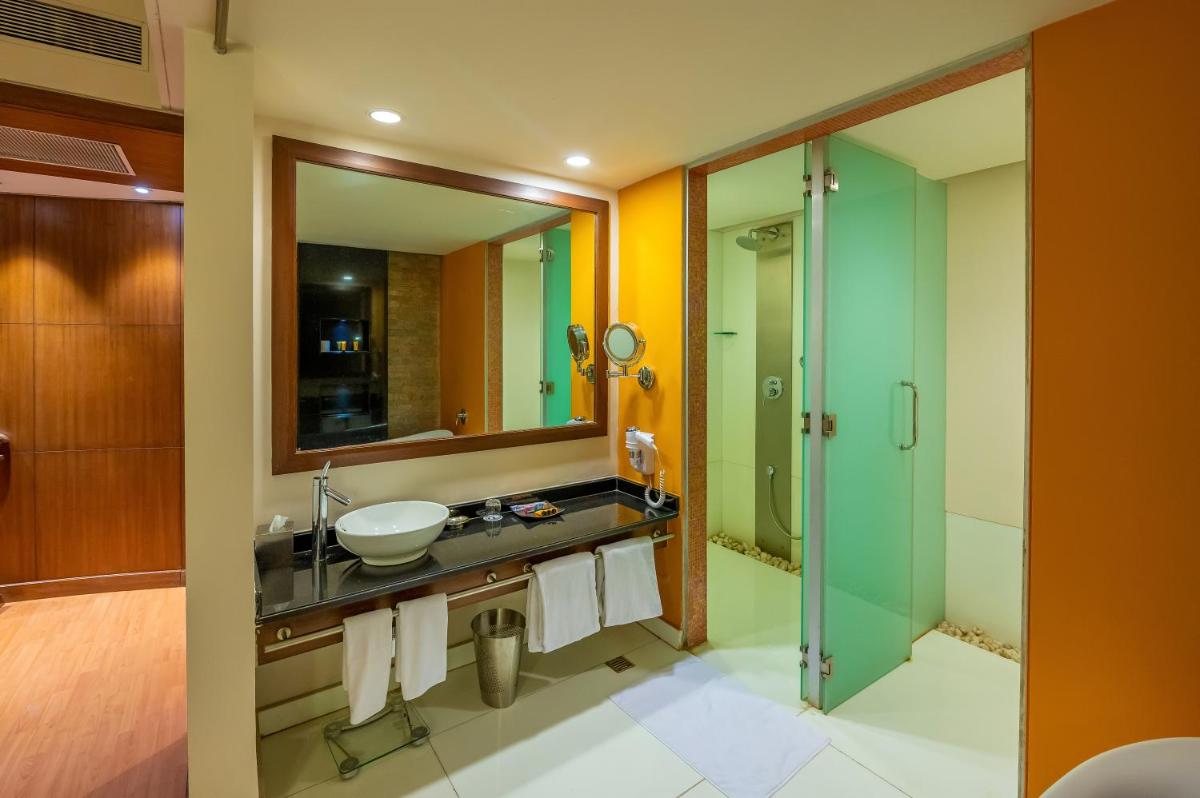 a bathroom with a sink and a mirror at O Hotel Pune in Pune