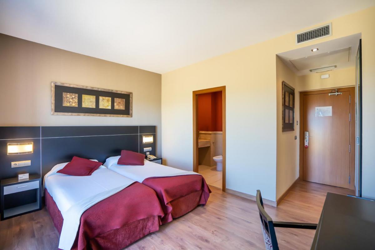 Cama o camas de una habitación en Hotel Andalussia
