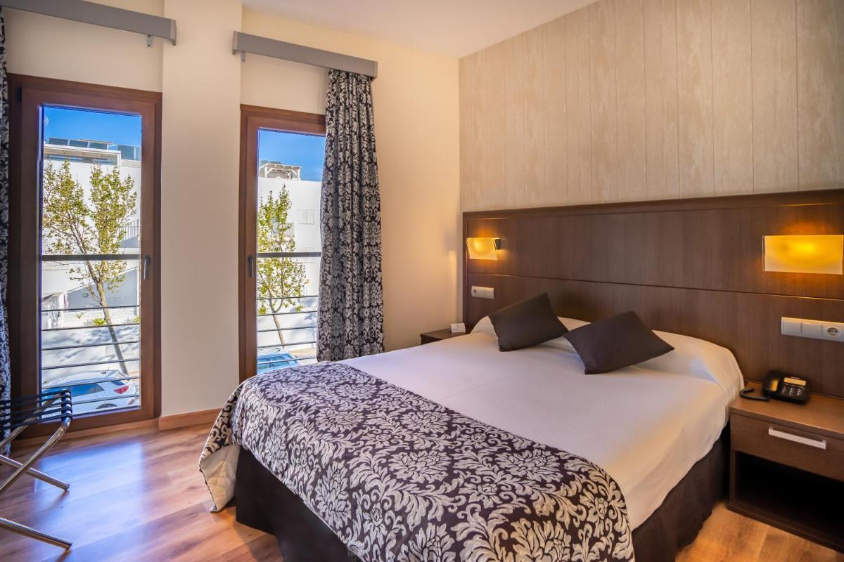 Cama o camas de una habitación en Hotel Andalussia