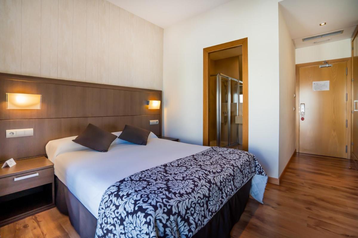 Cama o camas de una habitación en Hotel Andalussia