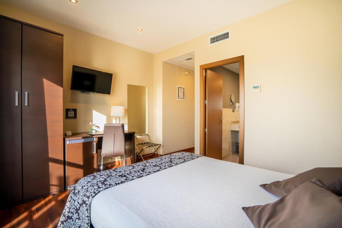 Cama o camas de una habitación en Hotel Andalussia