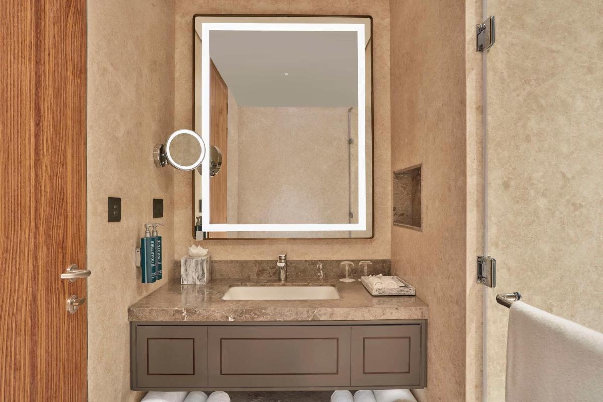 a bathroom with a sink and a mirror at Doubletree By Hilton Bengaluru Whitefield in Bengaluru