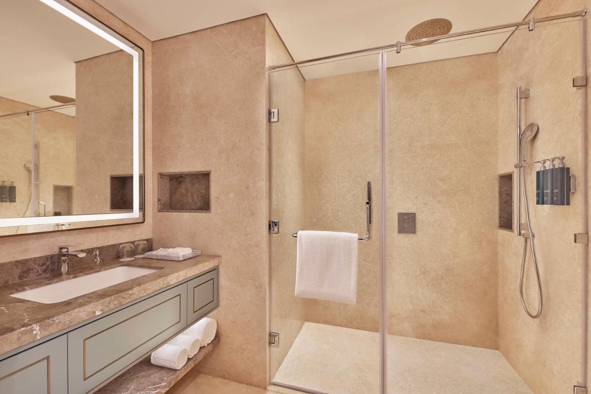 a bathroom with a shower and a sink at Doubletree By Hilton Bengaluru Whitefield in Bengaluru