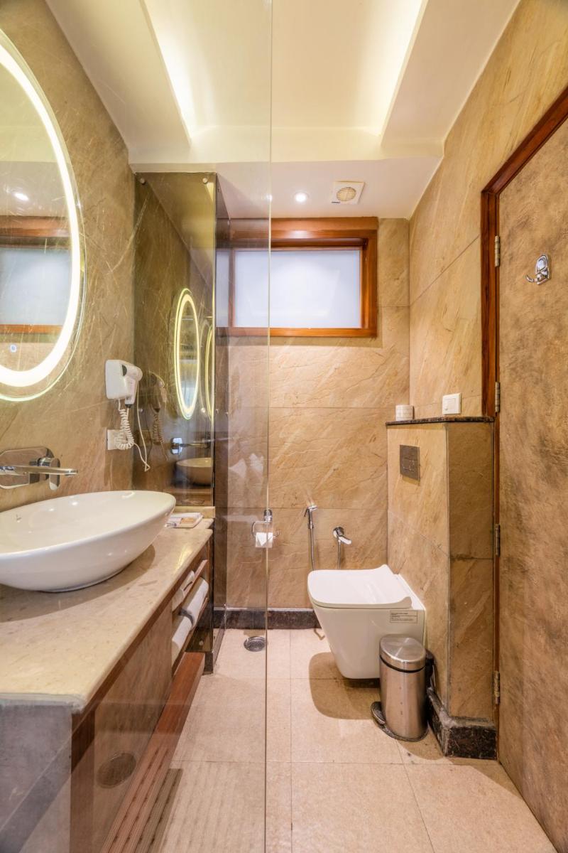 a bathroom with a sink and a toilet and a shower at Antalya By Divine Ganga Cottage in Rishīkesh