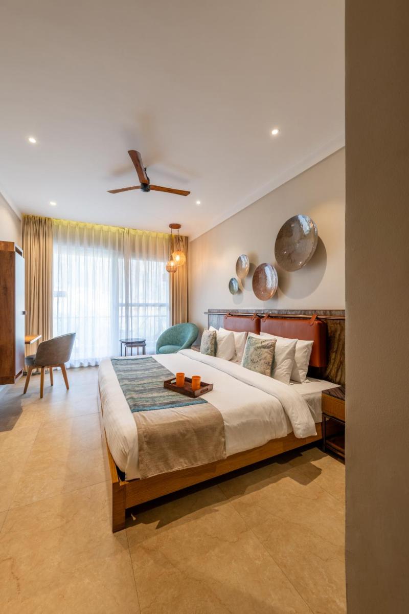 a bedroom with a large bed in a room at Antalya By Divine Ganga Cottage in Rishīkesh