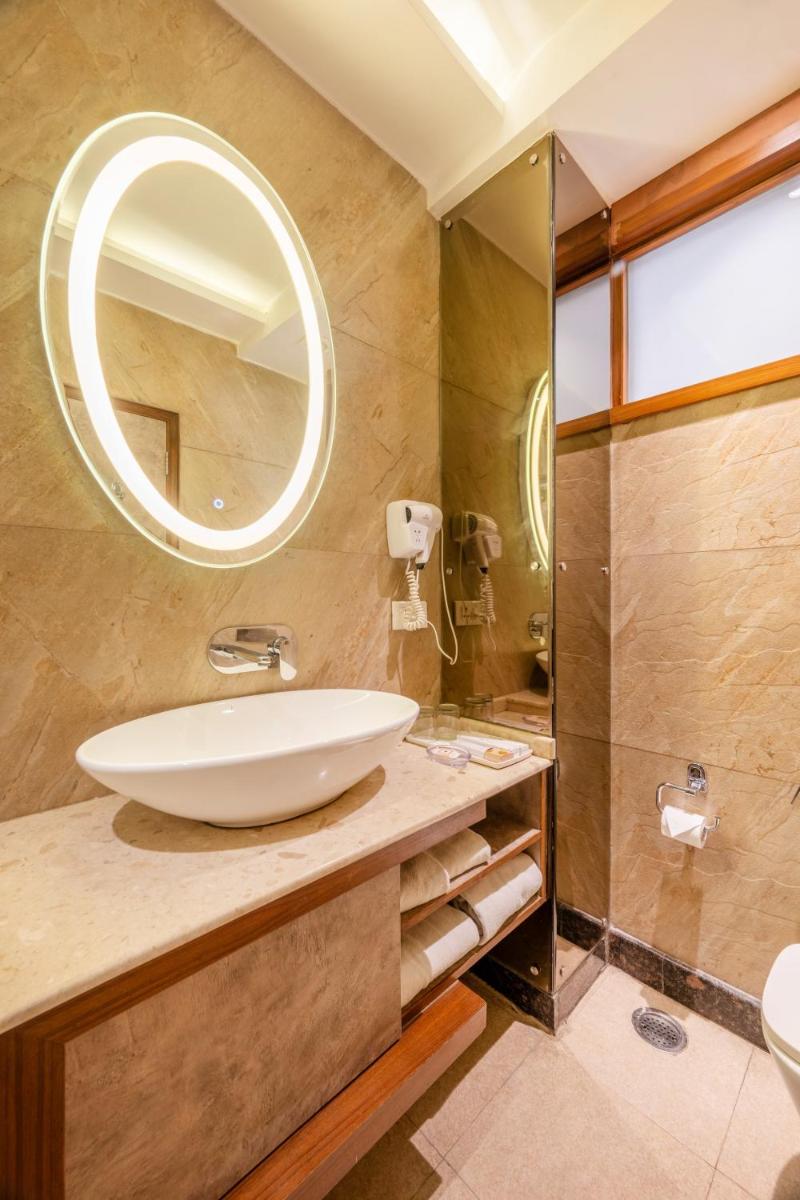 a bathroom with a sink and a mirror at Antalya By Divine Ganga Cottage in Rishīkesh