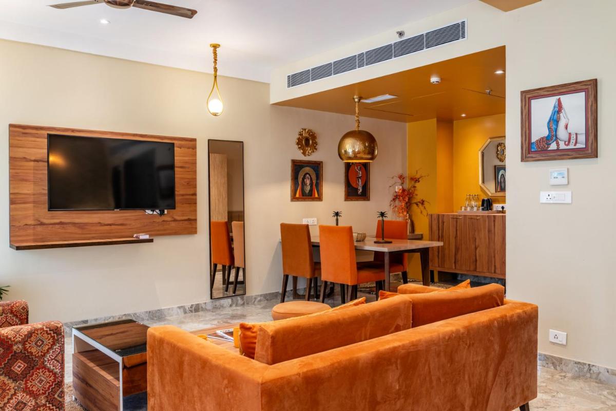 a living room with a couch and a table at Antalya By Divine Ganga Cottage in Rishīkesh