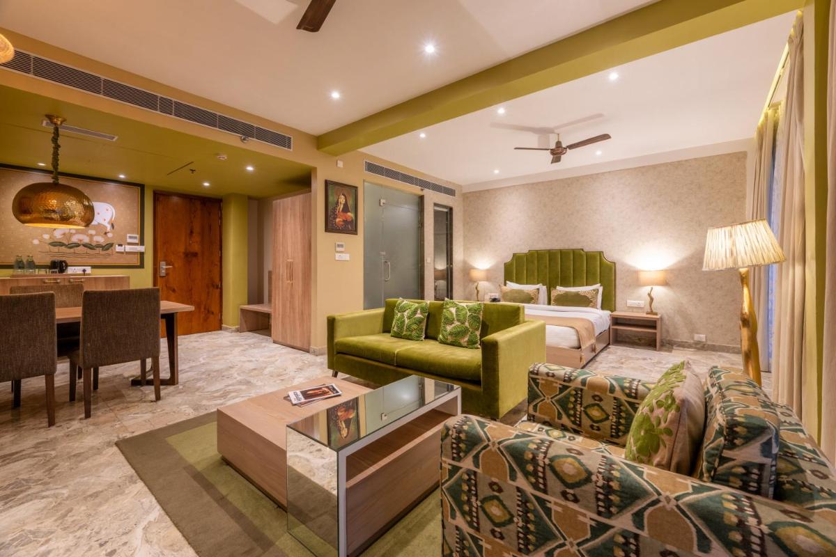 a living room with a couch and a table at Antalya By Divine Ganga Cottage in Rishīkesh