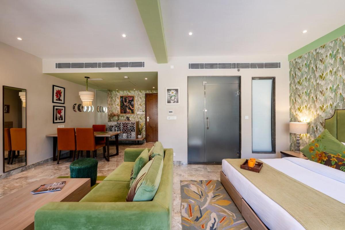 a bedroom with a bed and a living room at Antalya By Divine Ganga Cottage in Rishīkesh