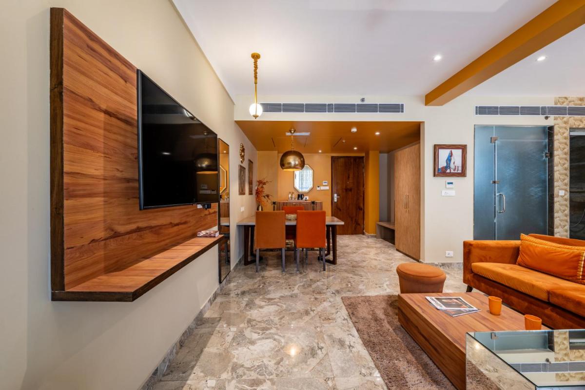 a living room with a couch and a table at Antalya By Divine Ganga Cottage in Rishīkesh