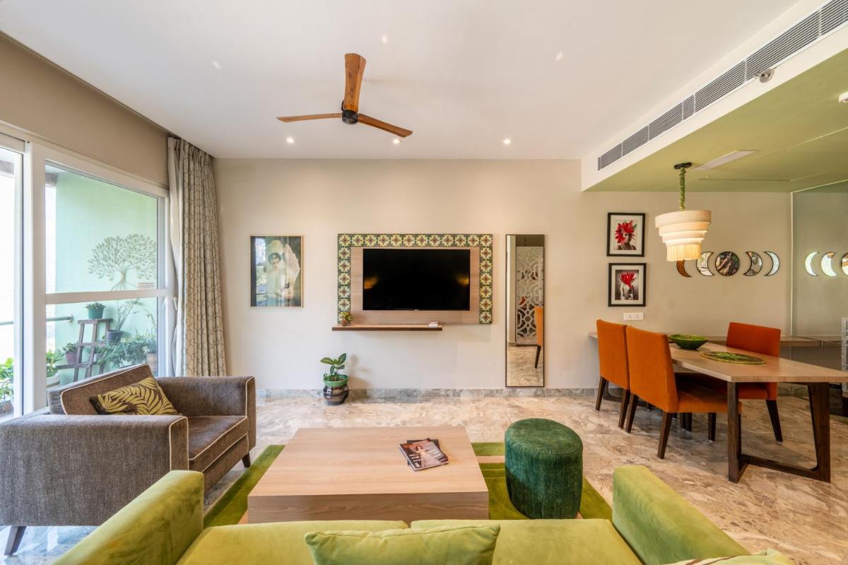 a living room with a couch and a table at Antalya By Divine Ganga Cottage in Rishīkesh
