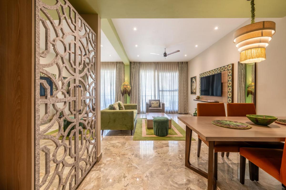 a dining room with a wall mural of a tree at Antalya By Divine Ganga Cottage in Rishīkesh