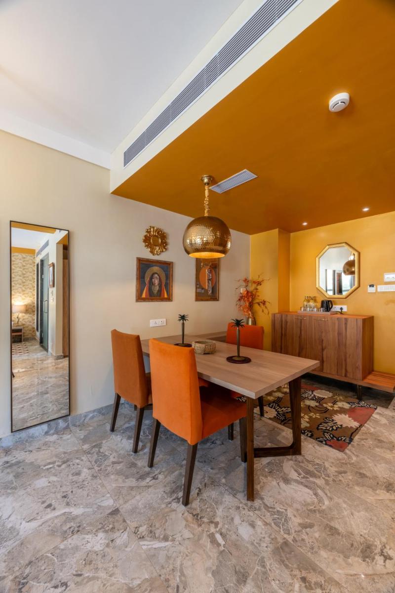 a dining room with a wooden table and chairs at Antalya By Divine Ganga Cottage in Rishīkesh