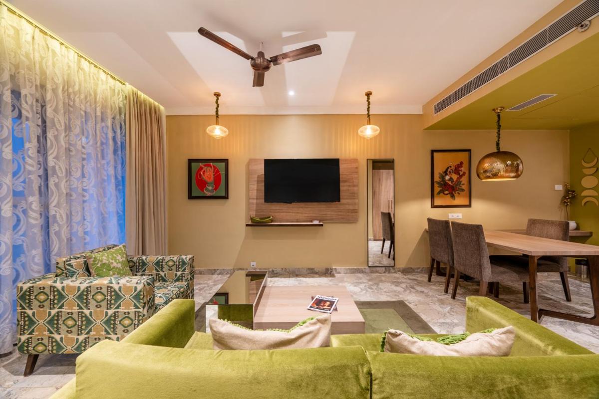 a living room with a couch and a table at Antalya By Divine Ganga Cottage in Rishīkesh