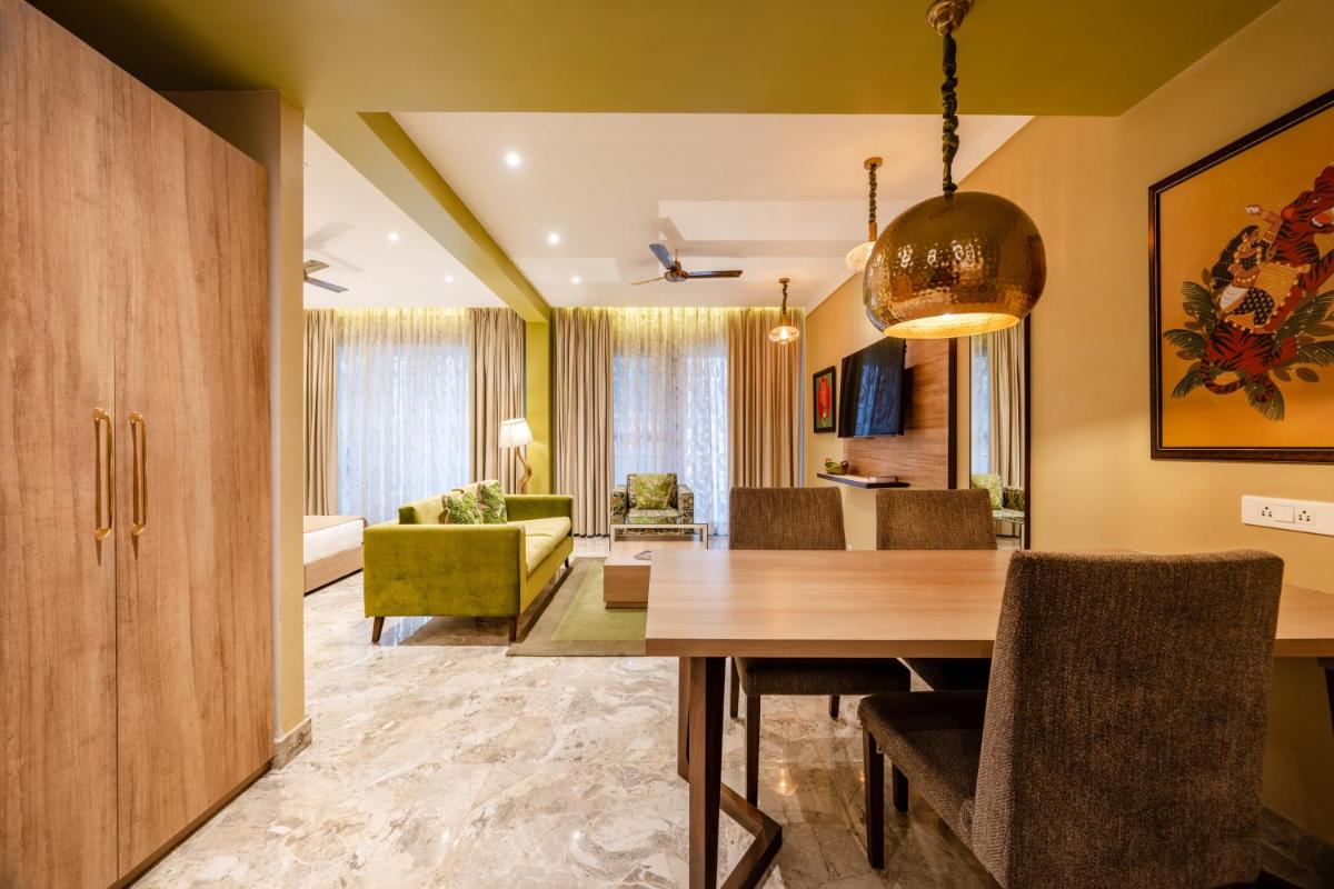 a dining room and living room with a dining table at Antalya By Divine Ganga Cottage in Rishīkesh