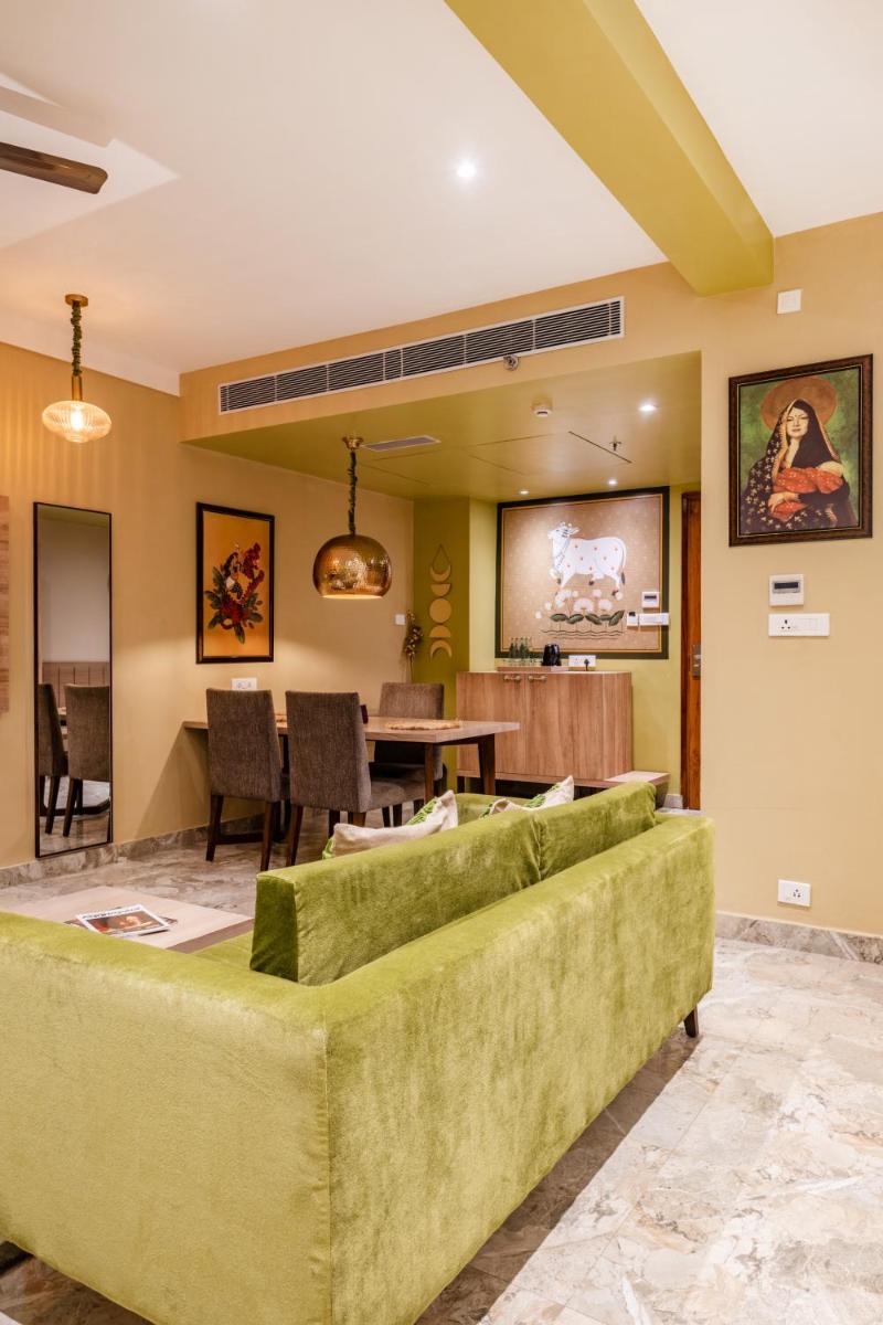 a living room with a couch and a table at Antalya By Divine Ganga Cottage in Rishīkesh