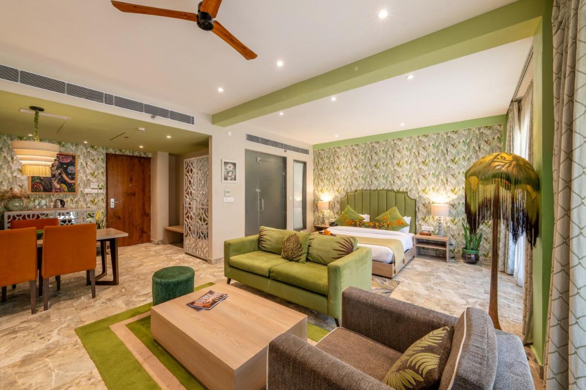 a living room with a couch and a dining room at Antalya By Divine Ganga Cottage in Rishīkesh