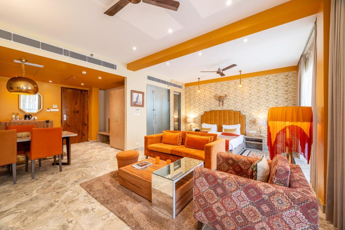 a living room with a couch and a table at Antalya By Divine Ganga Cottage in Rishīkesh