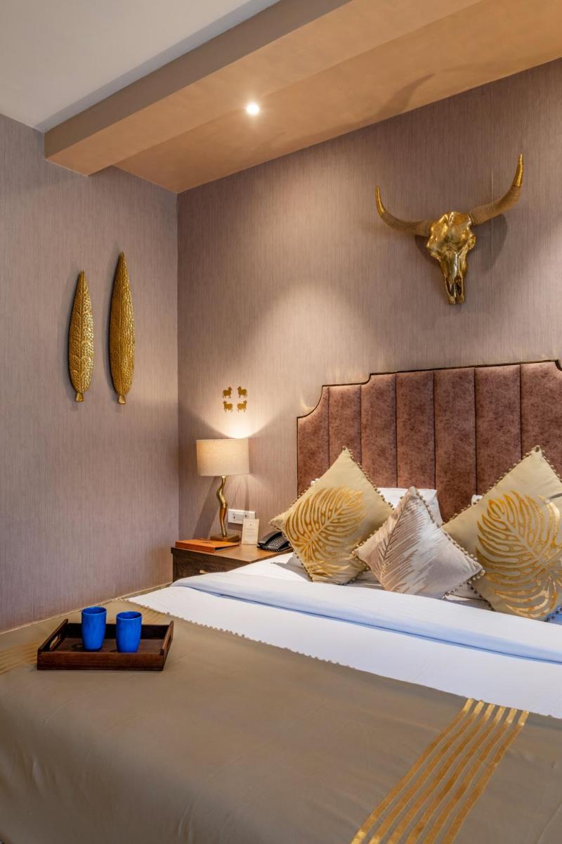 a bedroom with a large bed with a skull on the wall at Antalya By Divine Ganga Cottage in Rishīkesh