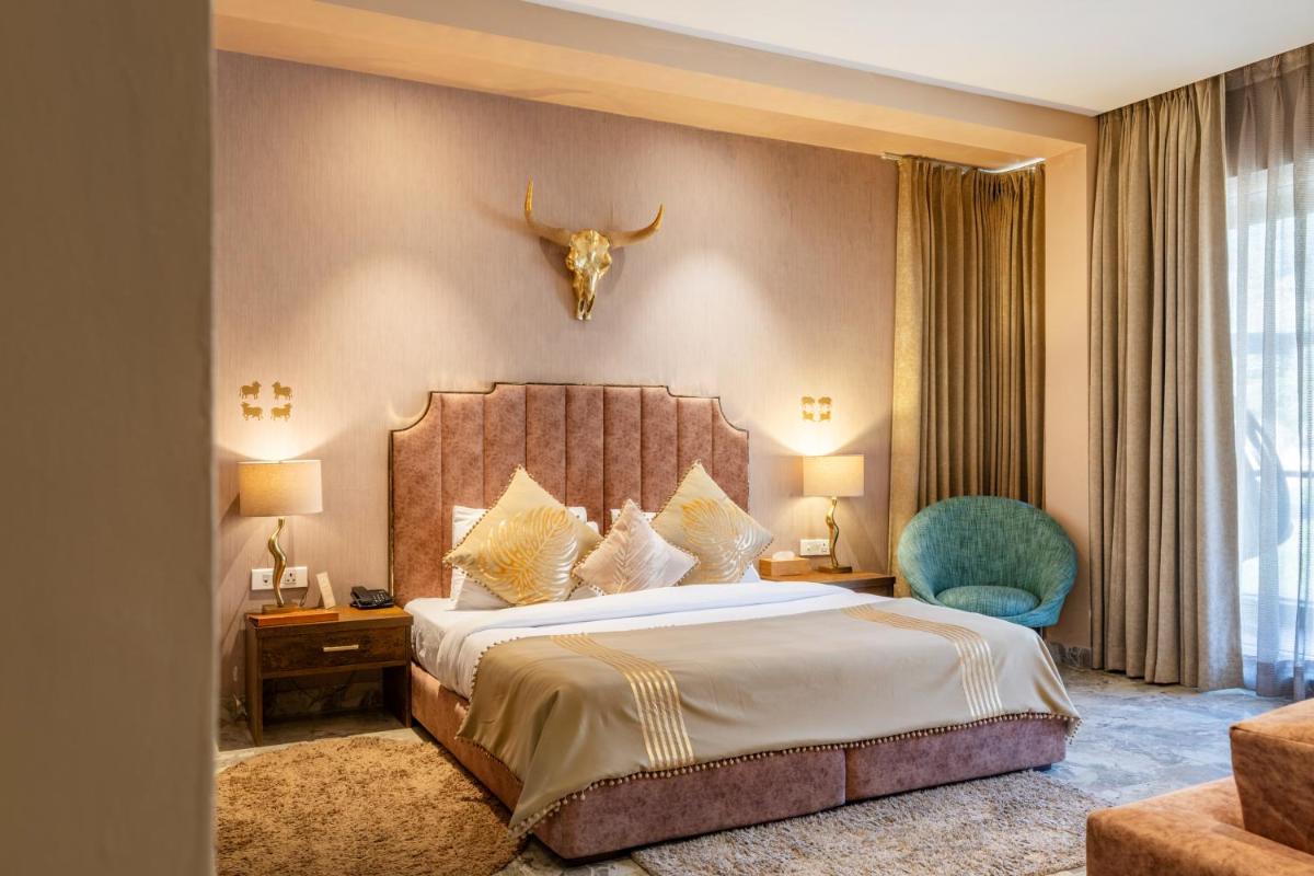 a hotel room with a bed and a skull on the wall at Antalya By Divine Ganga Cottage in Rishīkesh