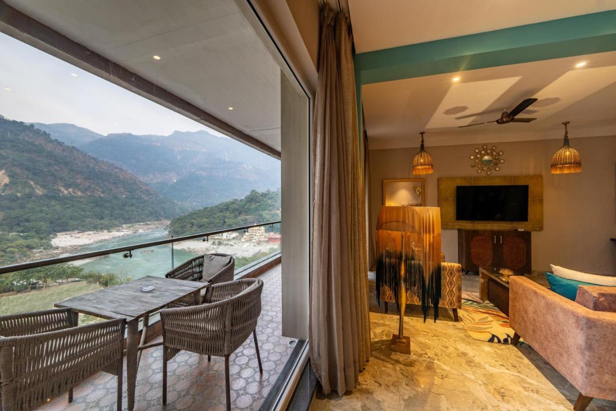 a living room with a view of the mountains at Antalya By Divine Ganga Cottage in Rishīkesh