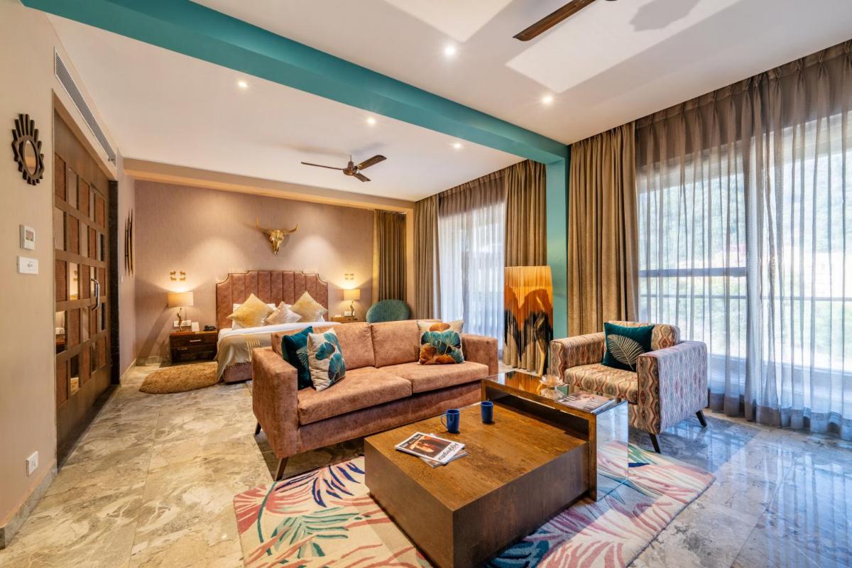 a living room with a couch and a table at Antalya By Divine Ganga Cottage in Rishīkesh