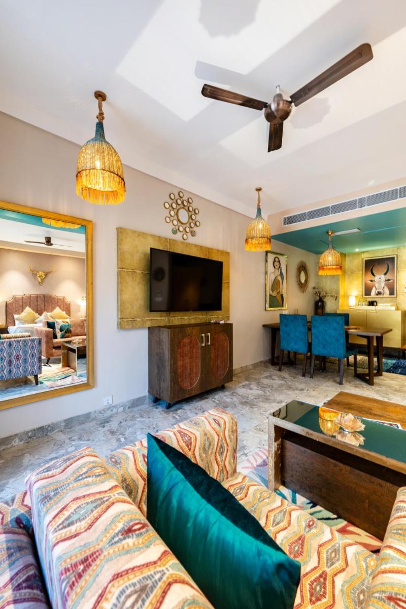 a living room with a couch and a tv at Antalya By Divine Ganga Cottage in Rishīkesh