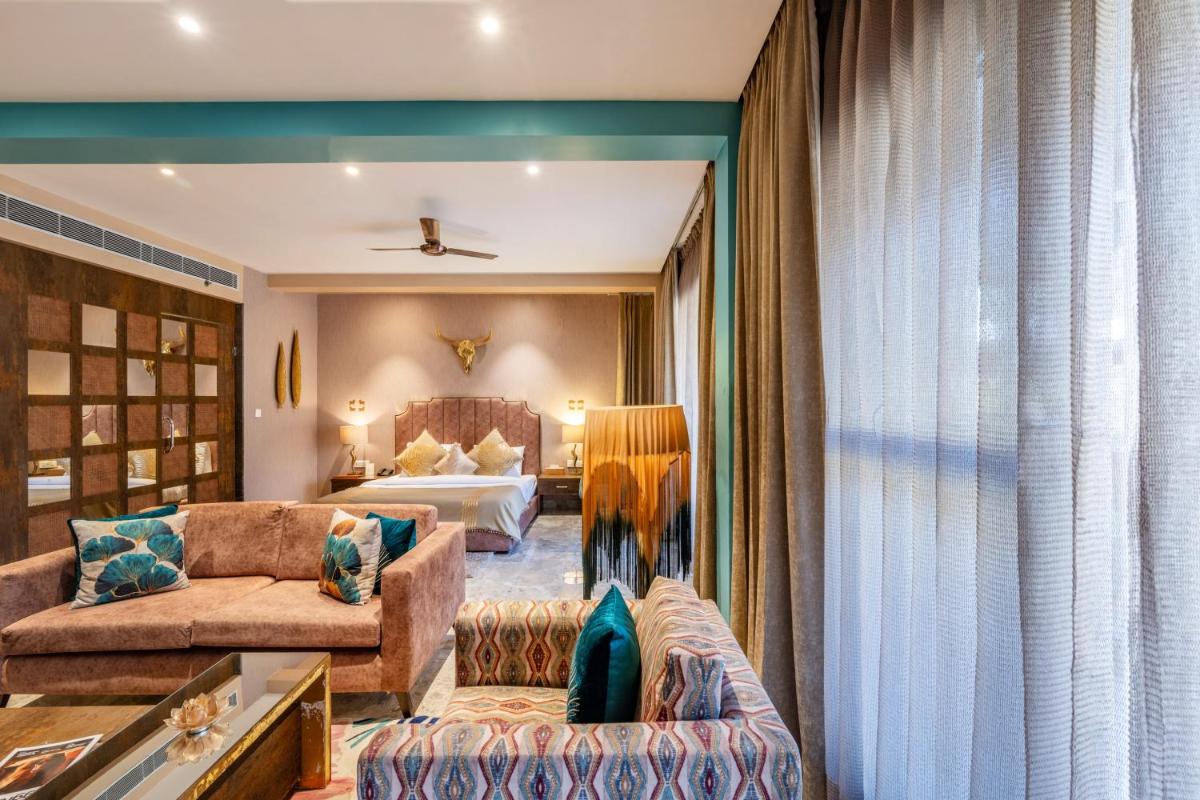 a living room with a couch and a bed at Antalya By Divine Ganga Cottage in Rishīkesh