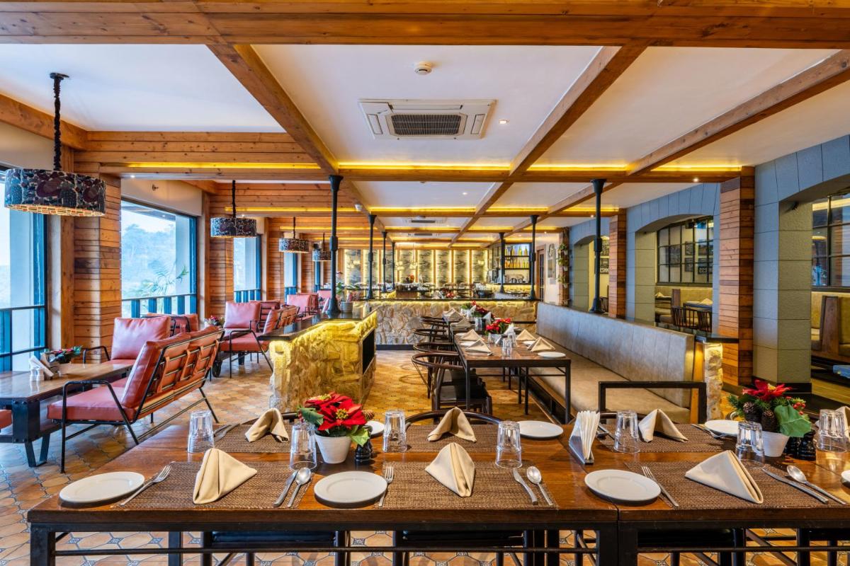 a dining room with tables and chairs at Antalya By Divine Ganga Cottage in Rishīkesh
