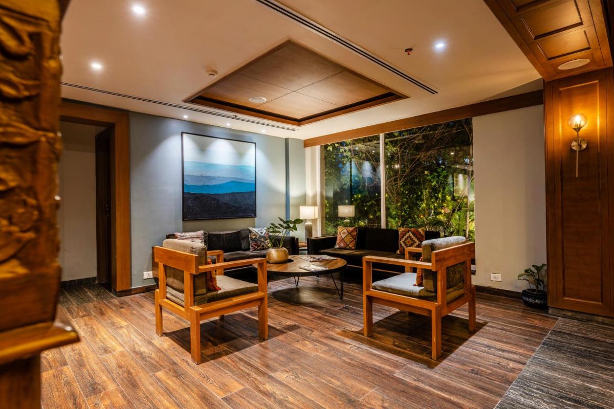 a living room with a couch and a table at Antalya By Divine Ganga Cottage in Rishīkesh