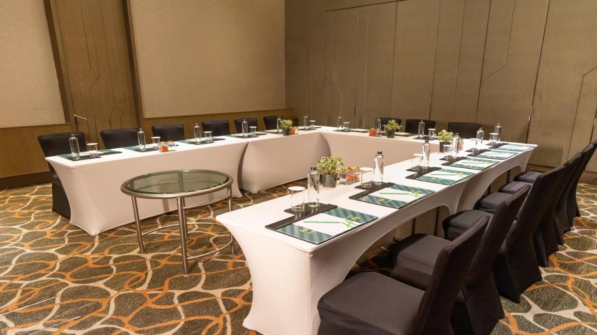 a long white table in a room with black chairs at Holiday Inn New Delhi Aerocity by IHG in New Delhi