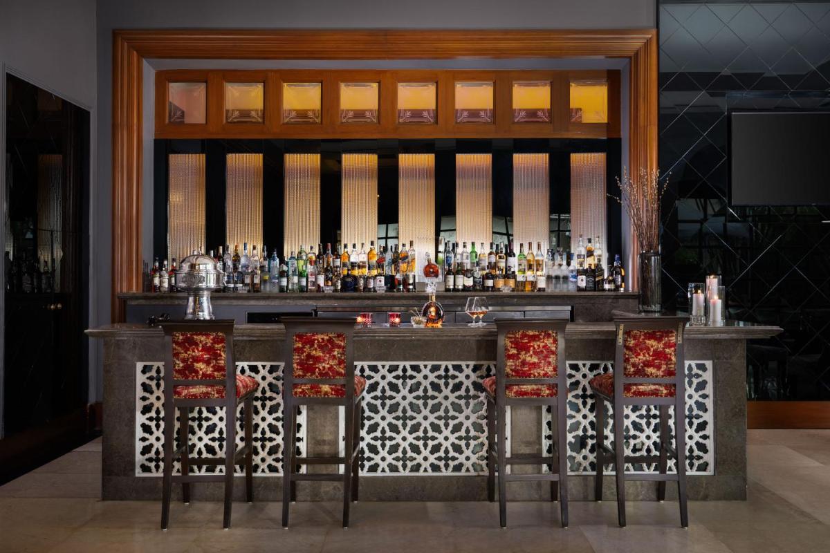 a bar with a lot of bottles of alcohol at Taj Krishna in Hyderabad