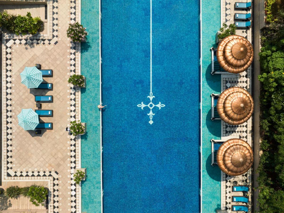 an overhead view of a swimming pool with chaise lounges at Taj Krishna in Hyderabad