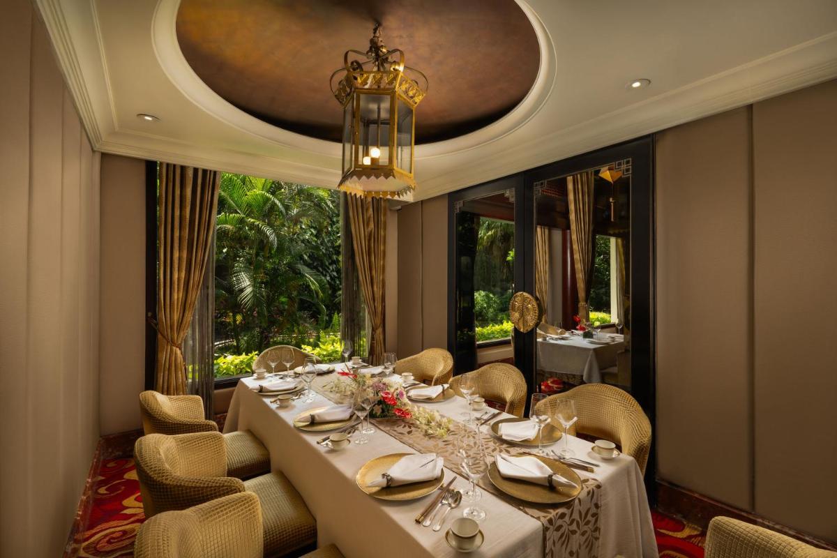 a dining room with a long table and chairs at Taj Krishna in Hyderabad