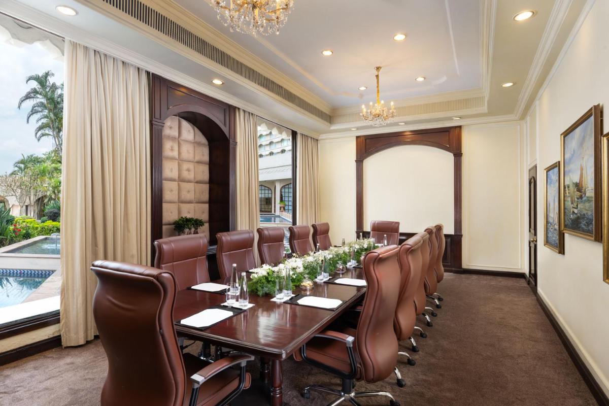 a conference room with a long table and chairs at Taj Krishna in Hyderabad