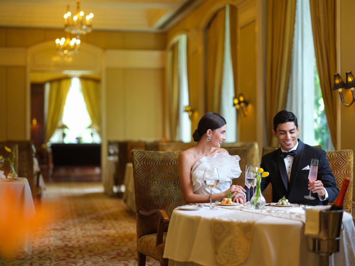 a bride and groom sitting at a table in a restaurant at Taj Krishna in Hyderabad