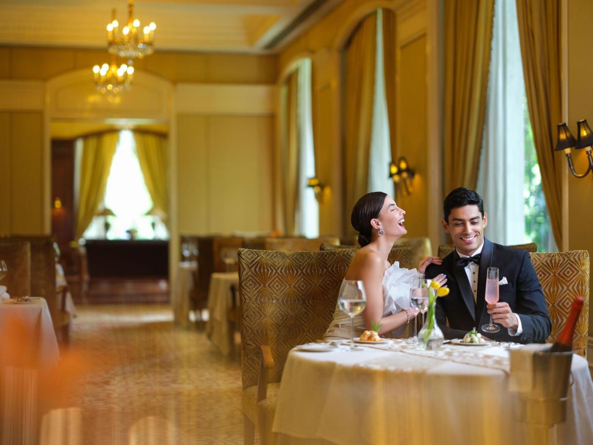 a bride and groom sitting at a table at Taj Krishna in Hyderabad