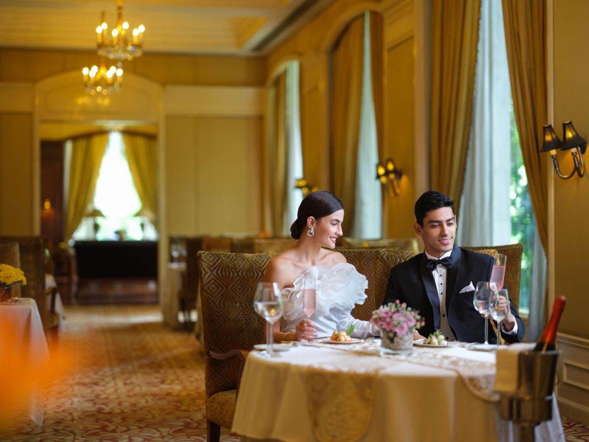 a bride and groom sitting at a table at Taj Krishna in Hyderabad