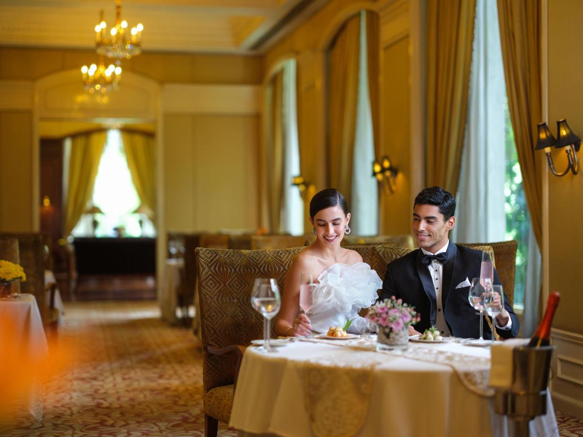 a bride and groom sitting at a table at Taj Krishna in Hyderabad