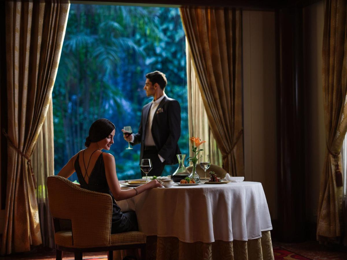 a man and woman sitting at a table in a restaurant at Taj Krishna in Hyderabad