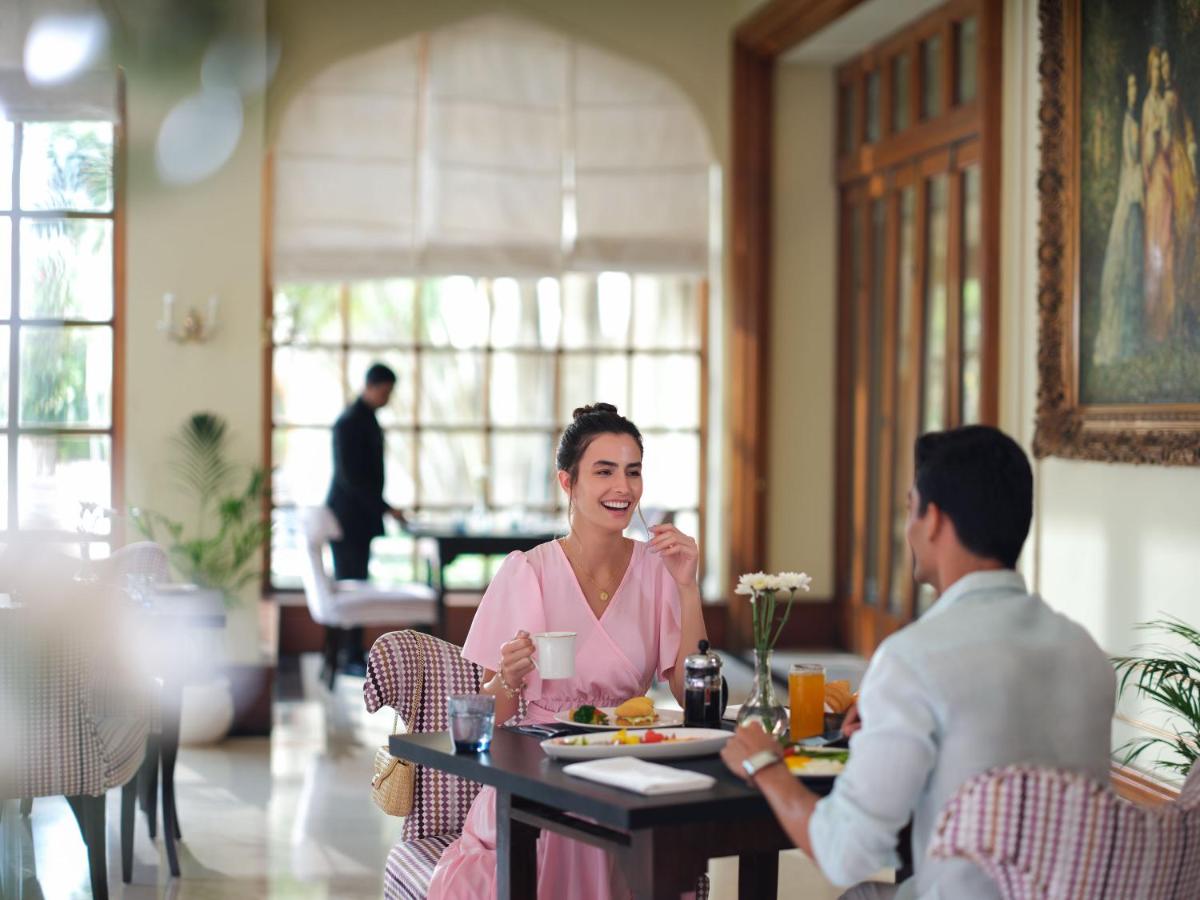 a woman sitting at a table with a man at Taj Krishna in Hyderabad