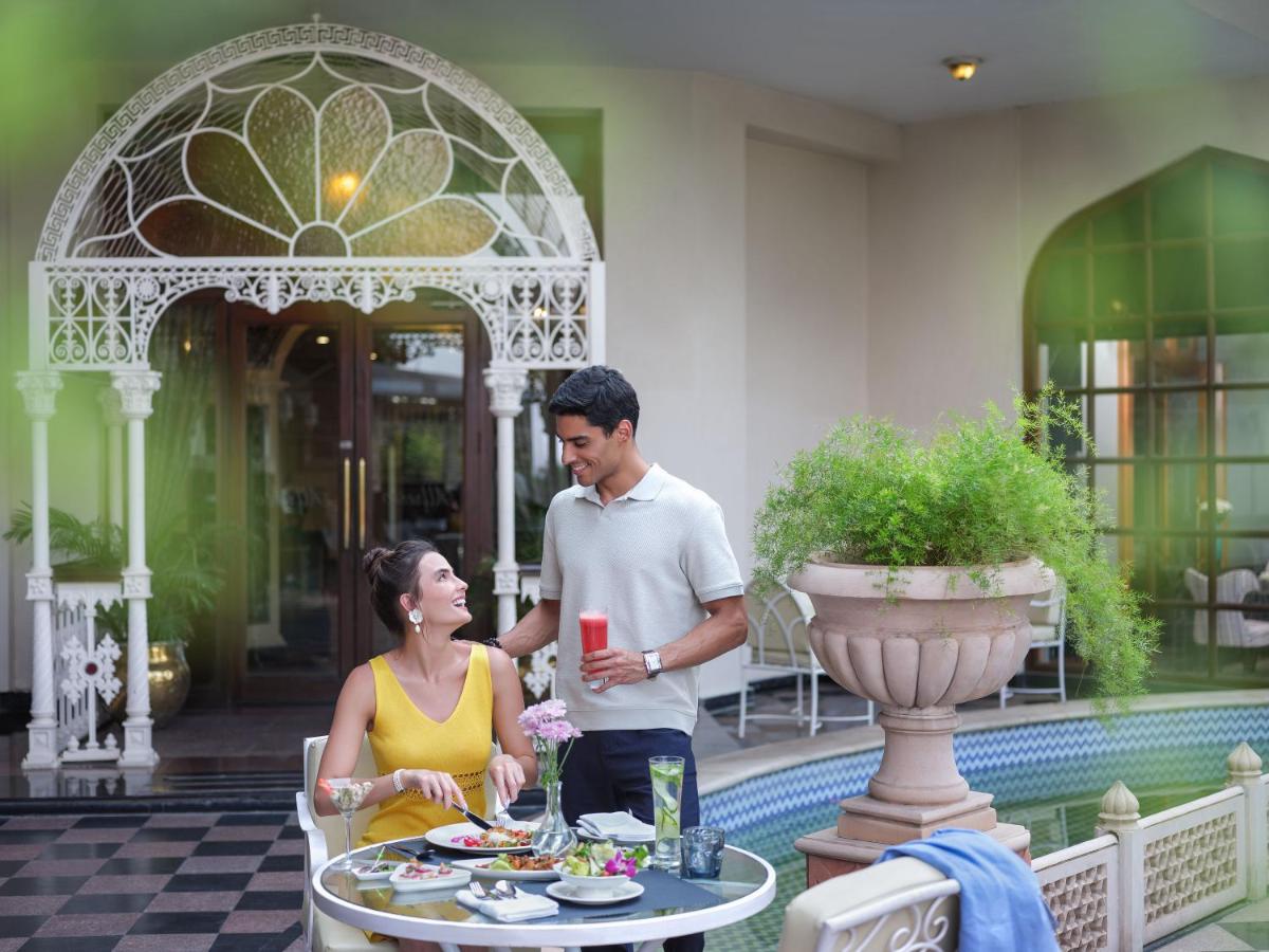 a man and a woman standing in front of a table at Taj Krishna in Hyderabad
