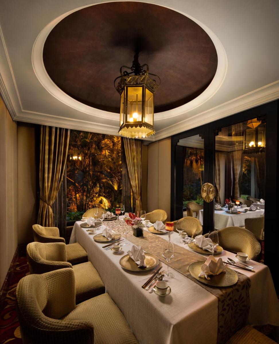 a dining room with a long table and chairs at Taj Krishna in Hyderabad