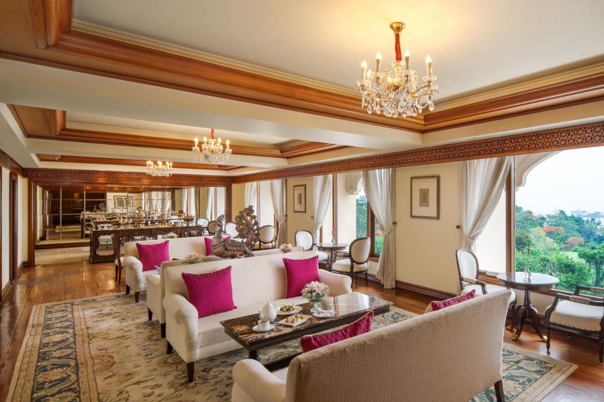 a living room filled with furniture and a chandelier at Taj Krishna in Hyderabad