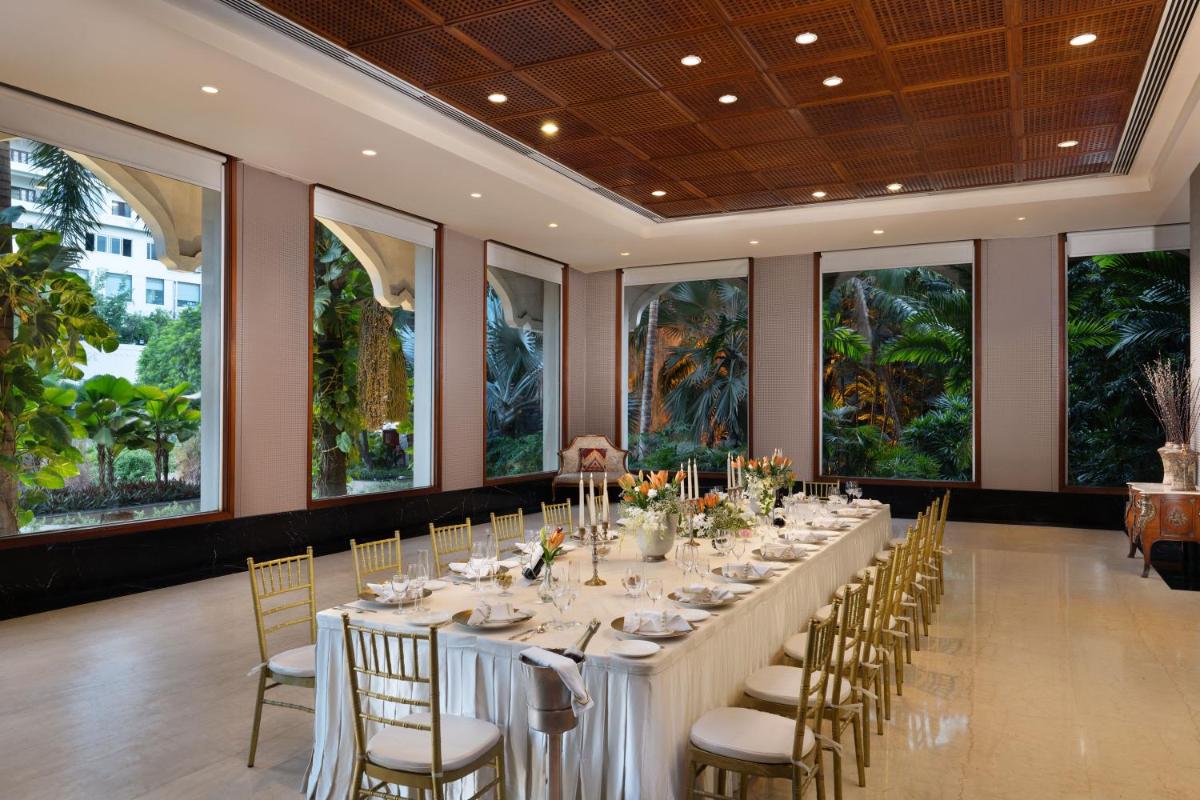 a long dining room with a long table and chairs at Taj Krishna in Hyderabad